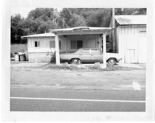 Polaroid image of car in a car port in America