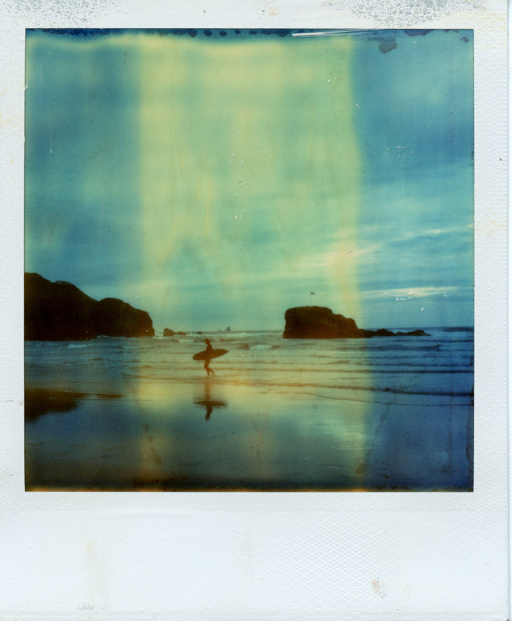 Polaroid image of a surfer and chapel rock reflections, Perranporth