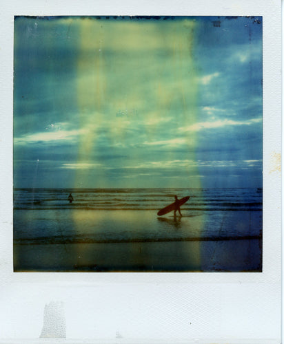 Polaroid photograph of a longboarder at Perranporth
