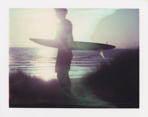 Polaroid of surfer at perran sands sunset