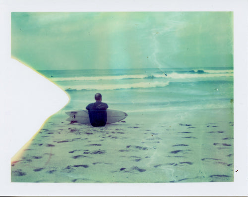 Polaroid image of a surfer with a twinfin at Sennen, Cornwall