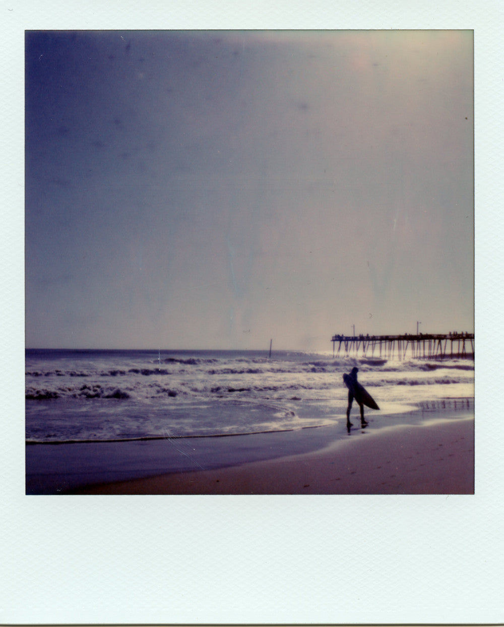 Surfer at Nags head pier shot on polaroid