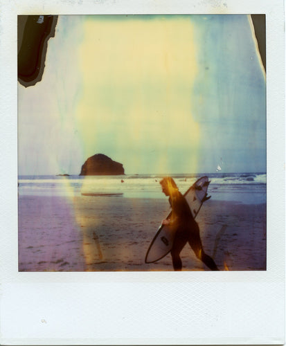 Polaroid image of a surfer at Trebarwith and Gull Rock in the distance