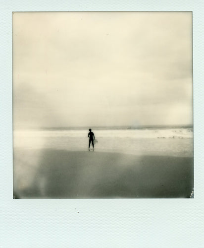 Black and white polaroid of a surfer at Chapel Porth