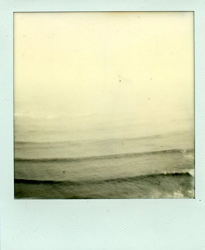 black and white polaroid of lines of waves