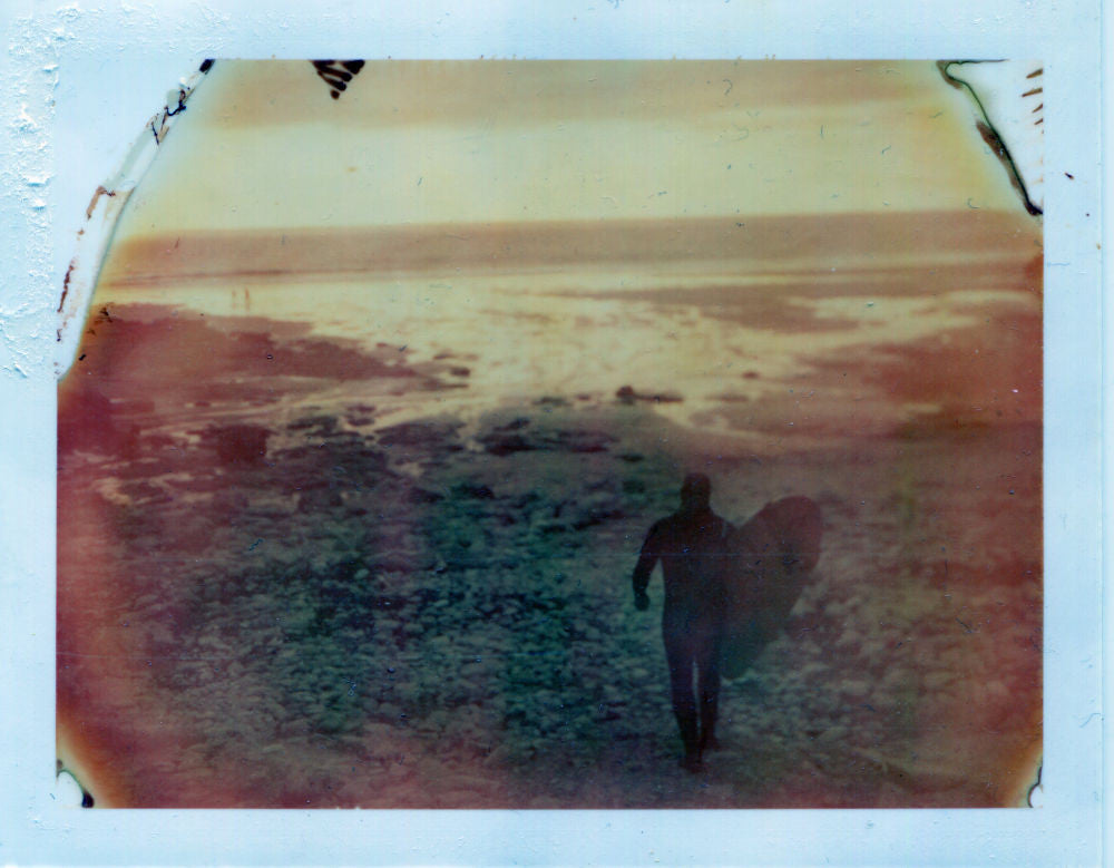 Polaroid image of a sunset and longboarder at chapel porth