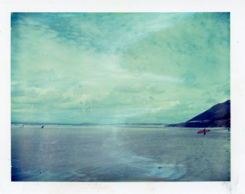 Polaroid of a longboarder at Rhosilli